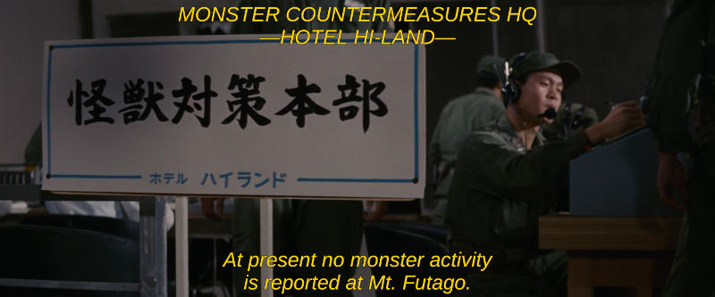 Military men sit working near a sign that says Monster Countermeasures HQ. The subtitle reads, At present no monster activity is reported at Mt. Futago.