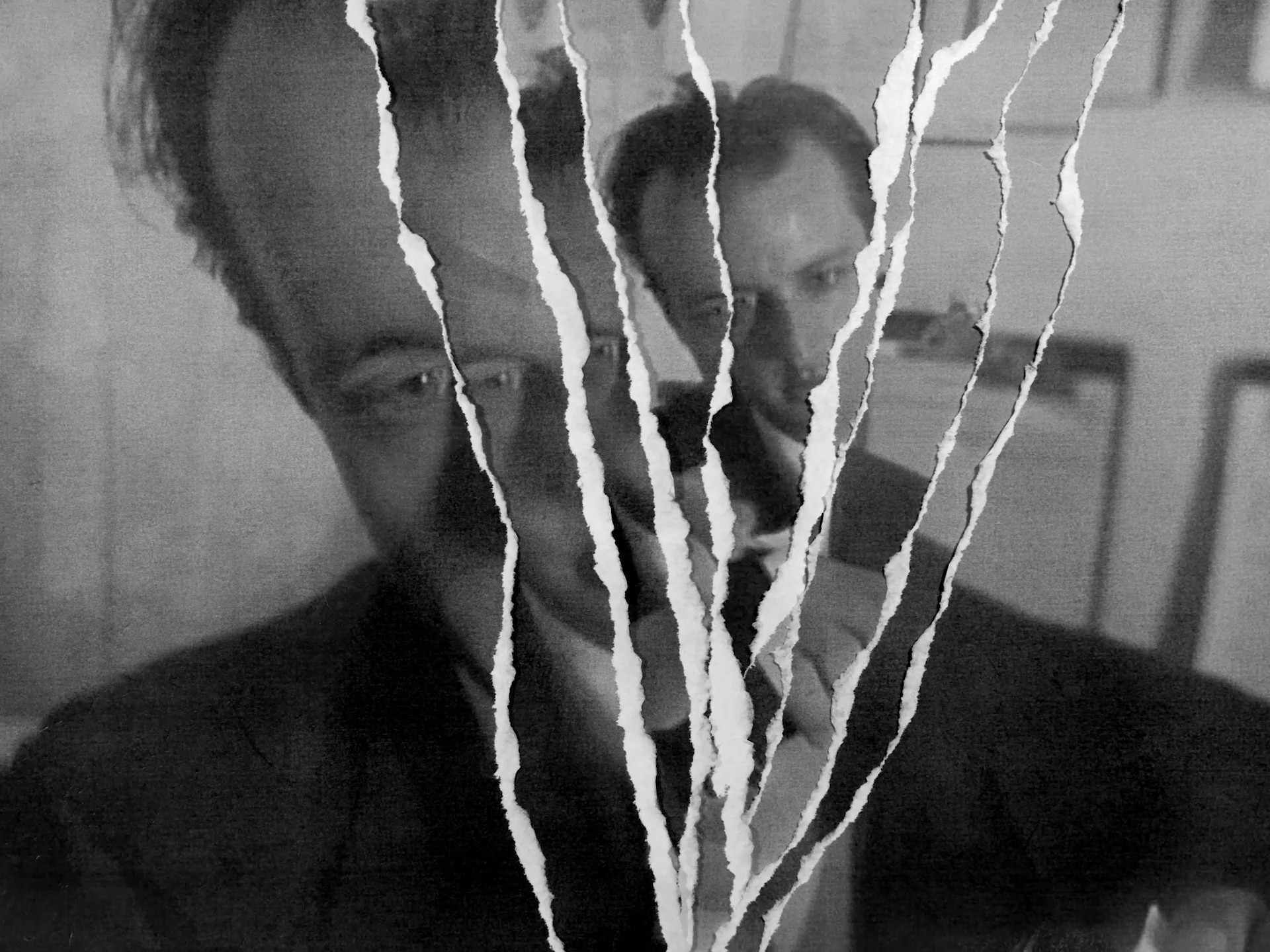 Black and white image of a man abstractly fractured into many by lightning lines of torn paper. From the film The Timekeepers of Eternity.